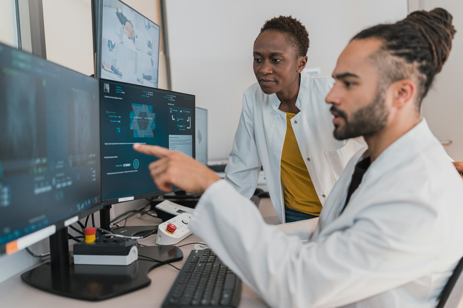 Two colleagues reviewing information on a screen together.